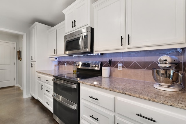 kitchen with decorative backsplash, stainless steel appliances, white cabinetry, and light stone countertops