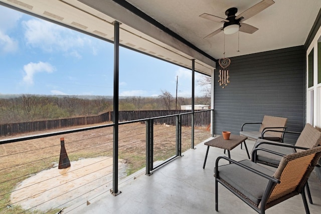 unfurnished sunroom with plenty of natural light and ceiling fan