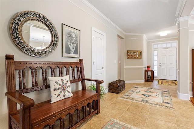 tiled foyer entrance with decorative columns and crown molding