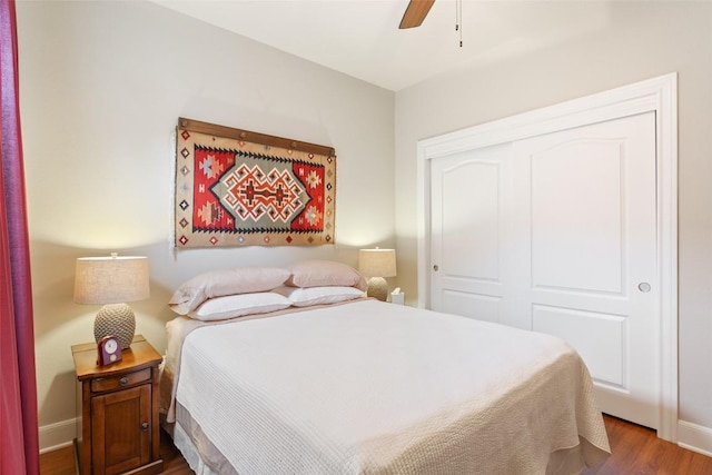 bedroom with ceiling fan, a closet, and wood-type flooring