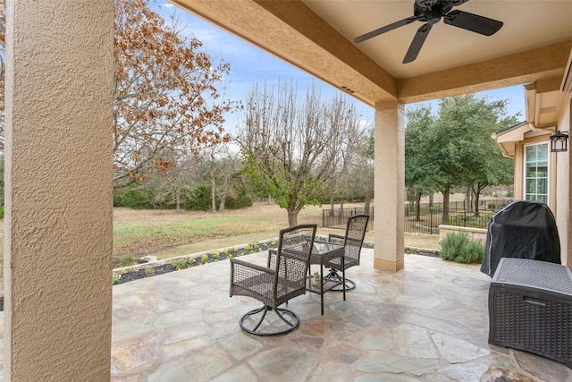 view of patio featuring area for grilling and ceiling fan