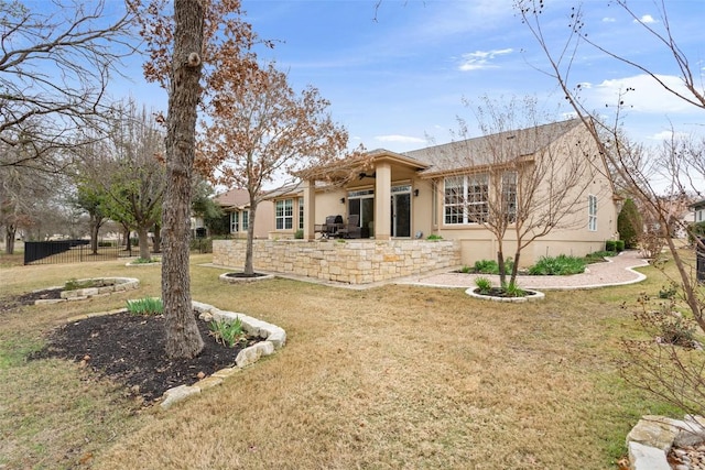 back of house with a lawn