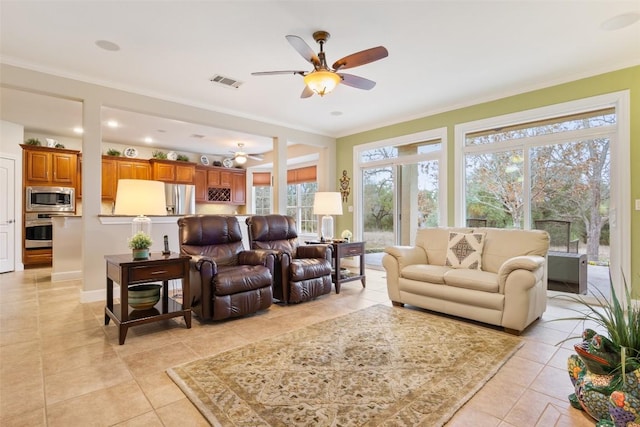 living room with ceiling fan, a healthy amount of sunlight, light tile patterned floors, and crown molding