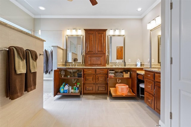 bathroom featuring ceiling fan, crown molding, and vanity