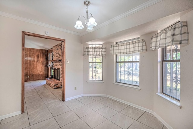 unfurnished dining area featuring a brick fireplace, light tile patterned flooring, ornamental molding, and an inviting chandelier