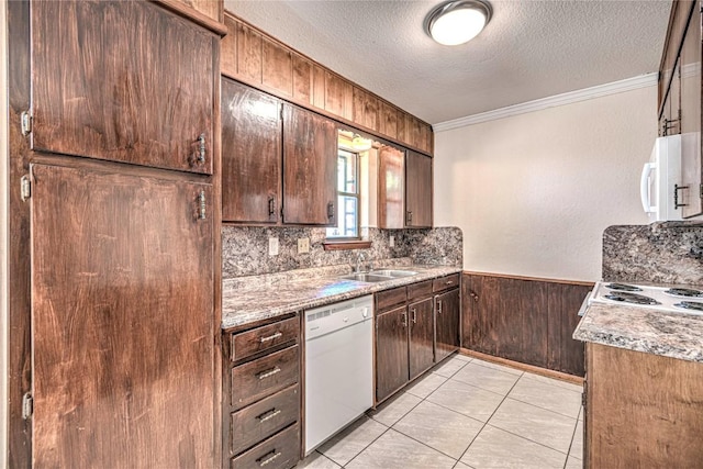 kitchen featuring white appliances, crown molding, sink, a textured ceiling, and light stone counters