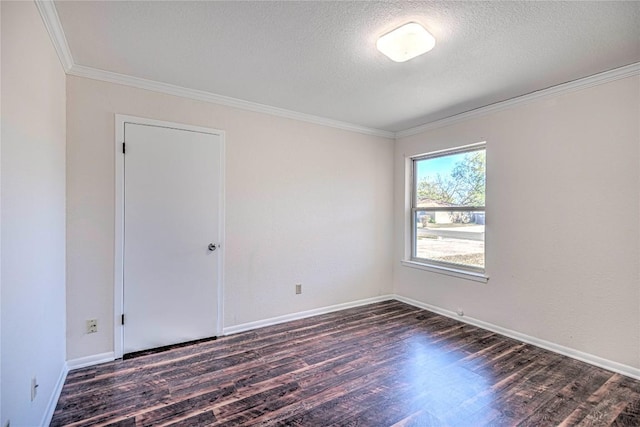 unfurnished room with a textured ceiling, dark hardwood / wood-style flooring, and crown molding