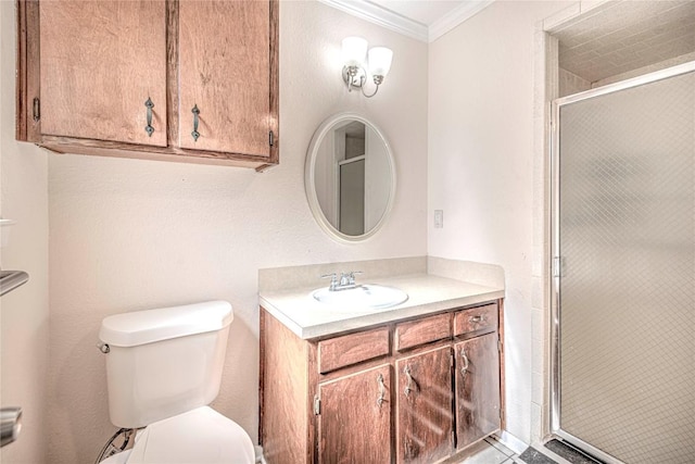 bathroom with crown molding, vanity, an enclosed shower, and toilet