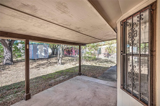 view of patio / terrace featuring a storage unit