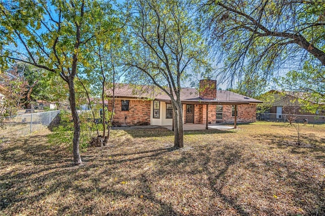 back of property with a patio