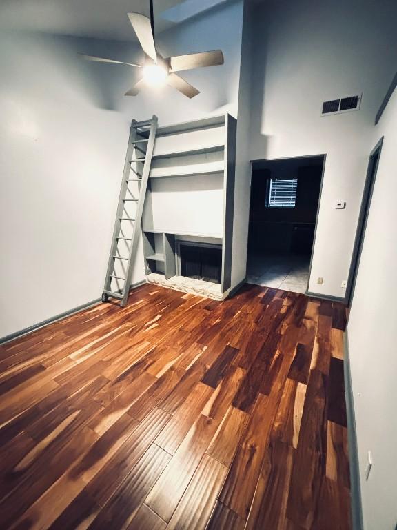 unfurnished bedroom featuring hardwood / wood-style flooring and ceiling fan