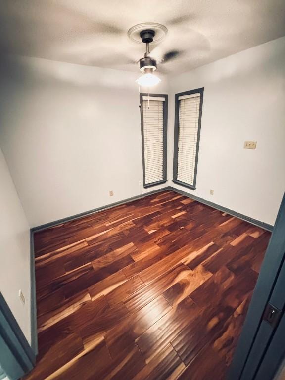 empty room with dark wood-type flooring