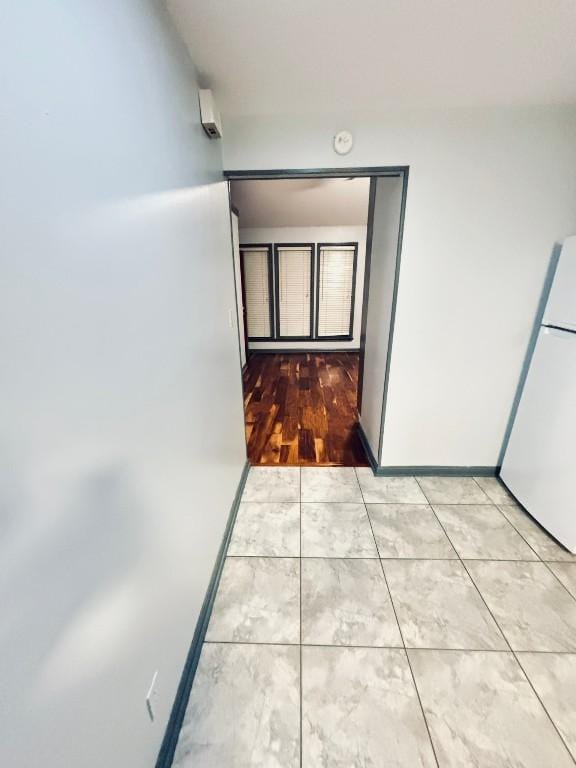 hall with light tile patterned floors