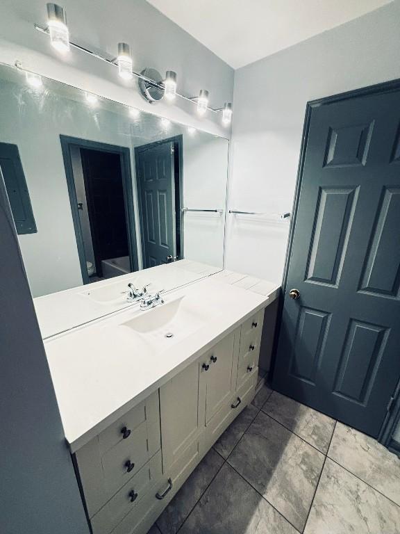 bathroom featuring tile patterned flooring and vanity