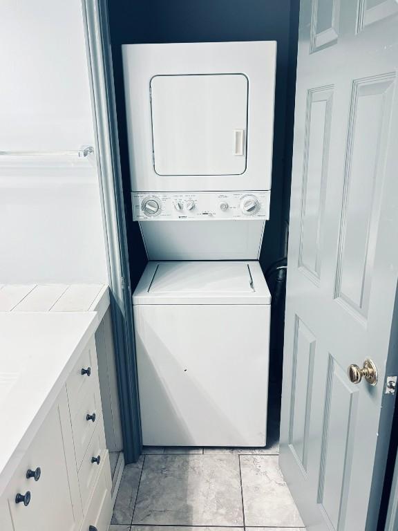 laundry room with stacked washing maching and dryer