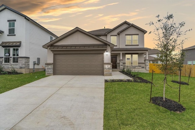 view of front of home featuring a garage and a yard