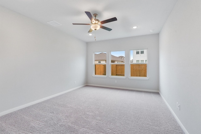 carpeted spare room with ceiling fan