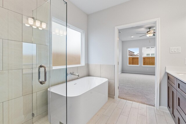 bathroom with vanity, ceiling fan, and independent shower and bath