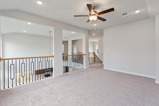 empty room with ceiling fan, carpet floors, and lofted ceiling