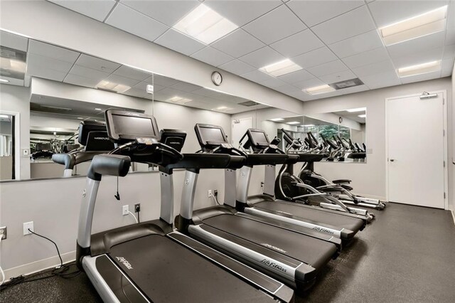 exercise room featuring a paneled ceiling