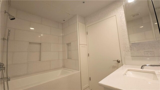 bathroom with vanity and bathing tub / shower combination