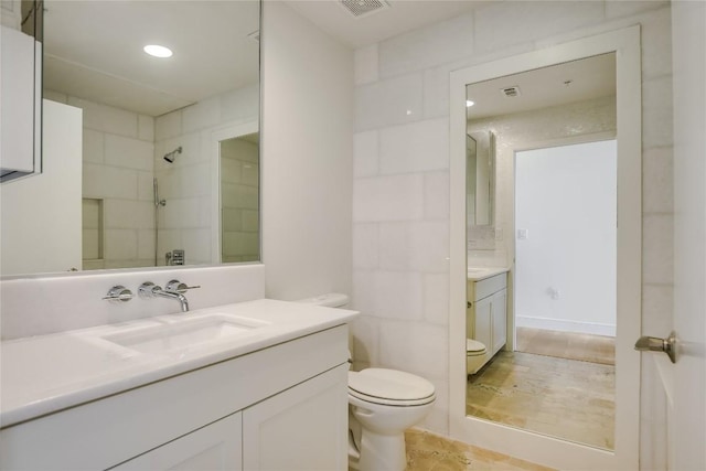 full bath featuring a shower, visible vents, vanity, and toilet