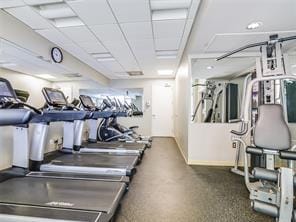 exercise room with a paneled ceiling