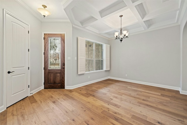 entryway featuring an inviting chandelier, beam ceiling, coffered ceiling, and light wood-type flooring