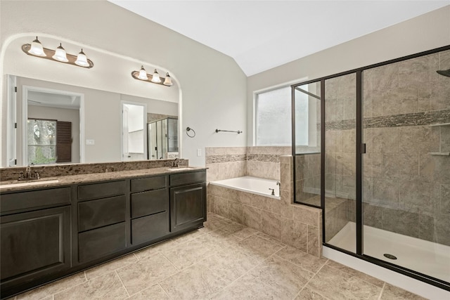 bathroom featuring lofted ceiling, vanity, and shower with separate bathtub