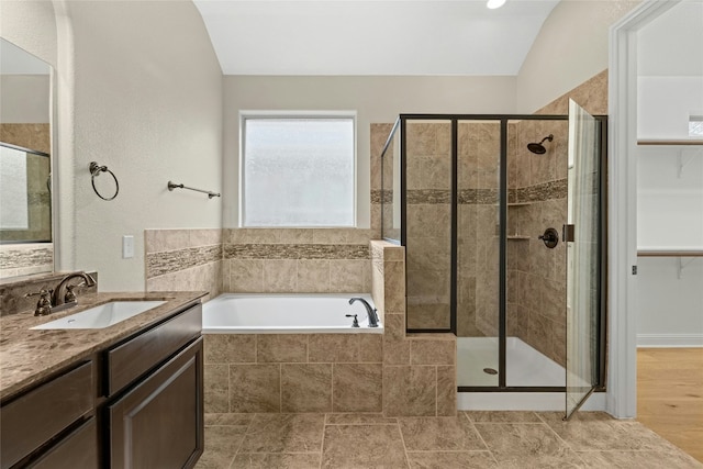 bathroom featuring plus walk in shower and vanity