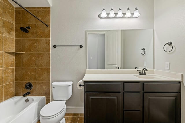 full bathroom featuring tile patterned floors, vanity, toilet, and tiled shower / bath combo