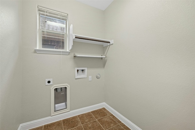 clothes washing area with electric dryer hookup, hookup for a washing machine, dark tile patterned floors, and gas dryer hookup