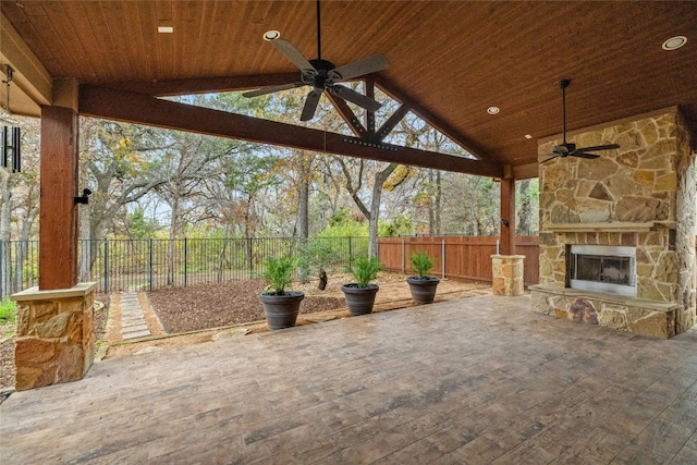 view of patio with ceiling fan and an outdoor stone fireplace