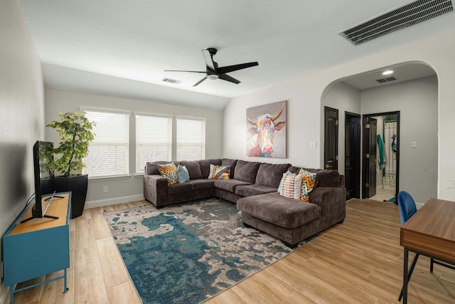 living room featuring wood-type flooring, ceiling fan, and lofted ceiling