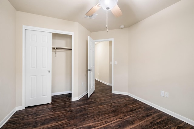 unfurnished bedroom with ceiling fan, dark hardwood / wood-style flooring, and a closet