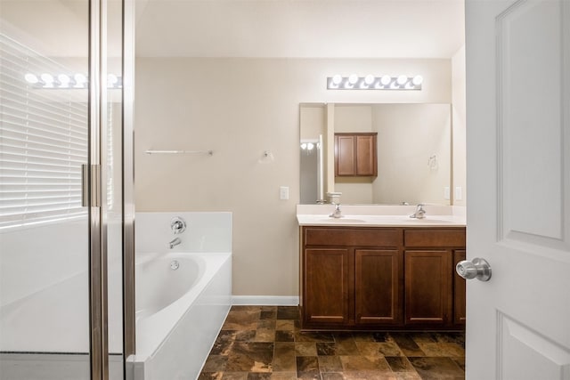 bathroom featuring a bath and vanity