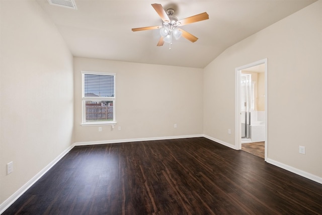 empty room with lofted ceiling, ceiling fan, and dark hardwood / wood-style floors