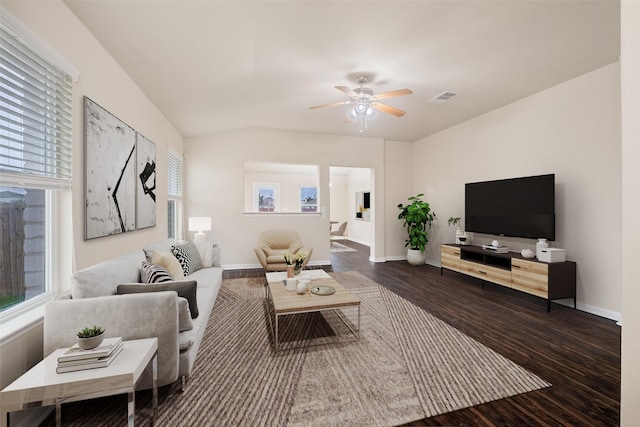 living room with ceiling fan and dark wood-type flooring