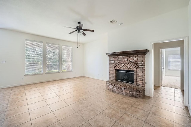 unfurnished living room with ceiling fan, light tile patterned floors, and a fireplace