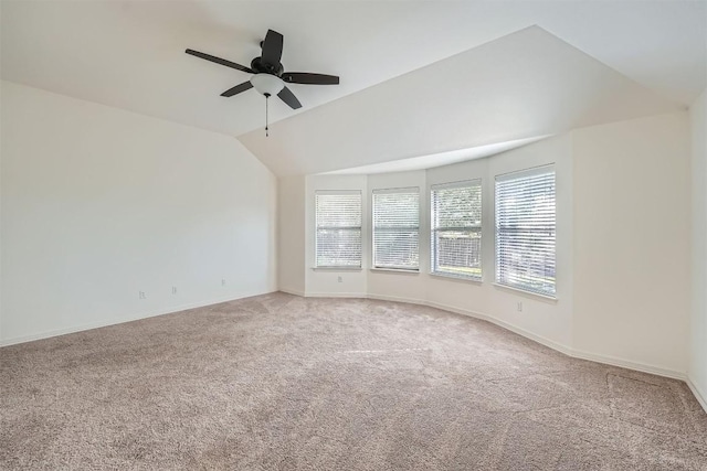 unfurnished room with ceiling fan, carpet floors, and vaulted ceiling