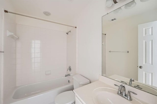 full bathroom featuring vanity, tiled shower / bath combo, and toilet