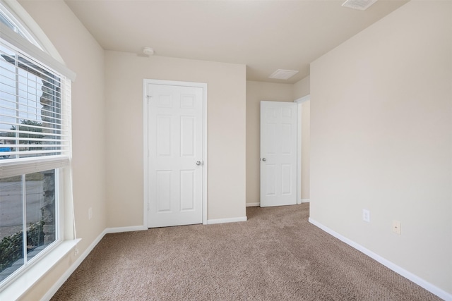 unfurnished bedroom with carpet flooring