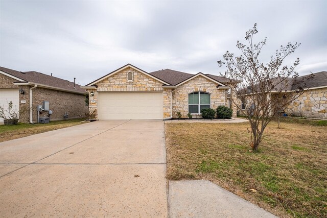 ranch-style home with a front lawn and a garage