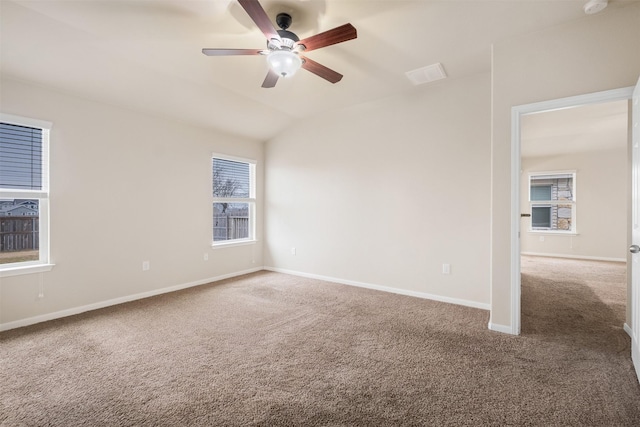 carpeted empty room featuring lofted ceiling and ceiling fan