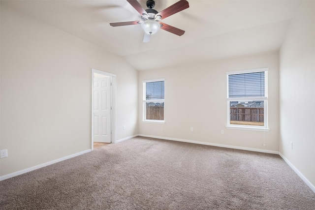 carpeted spare room with lofted ceiling and ceiling fan