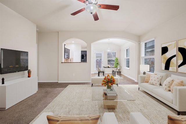 living room featuring ceiling fan, carpet, and vaulted ceiling