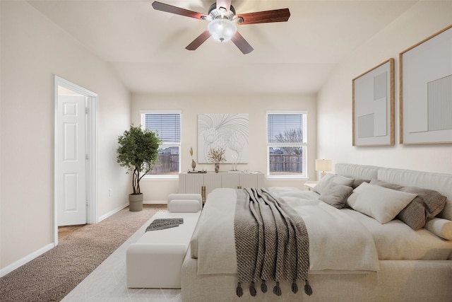 carpeted bedroom featuring ceiling fan and vaulted ceiling