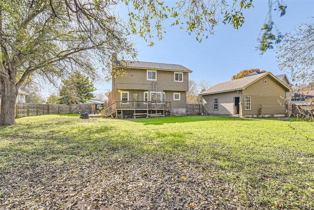 back of property with a deck and a lawn