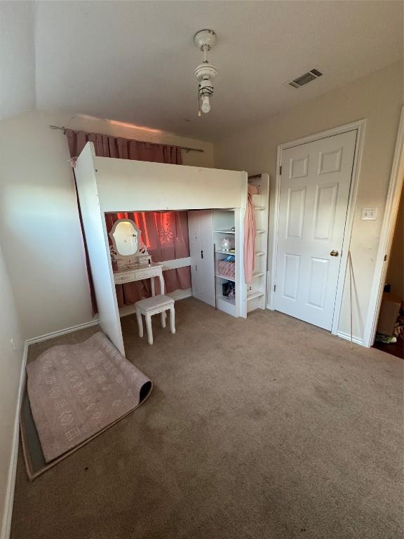 unfurnished bedroom with carpet floors and lofted ceiling