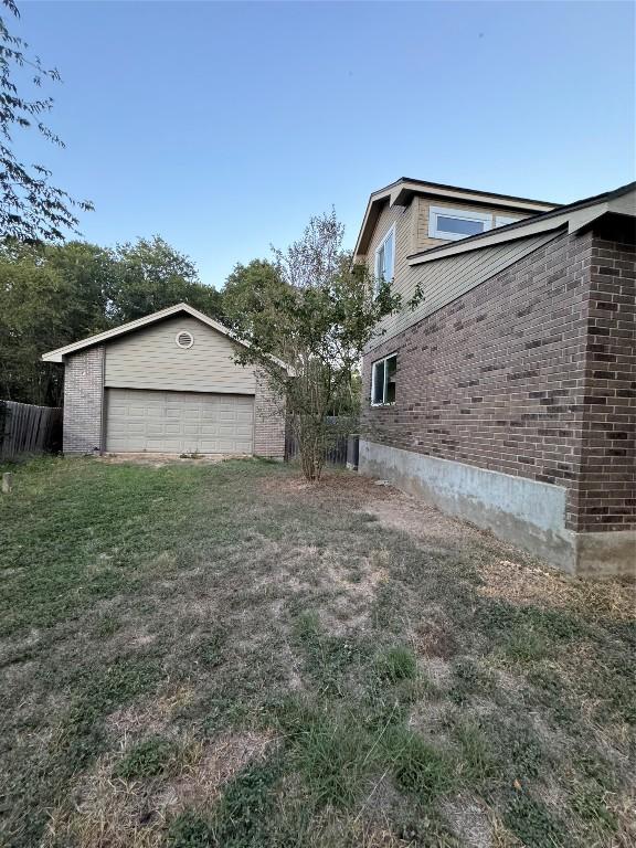 view of property exterior with an outbuilding, a garage, and a lawn